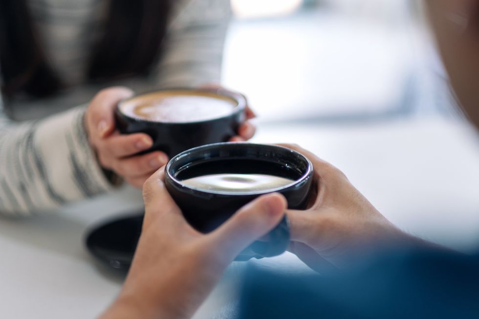 A couple sharing a cup of coffee.