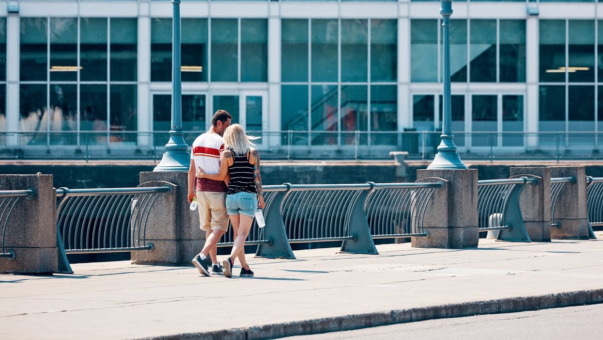 A couple walks along Old Port Harbor in Montreal.