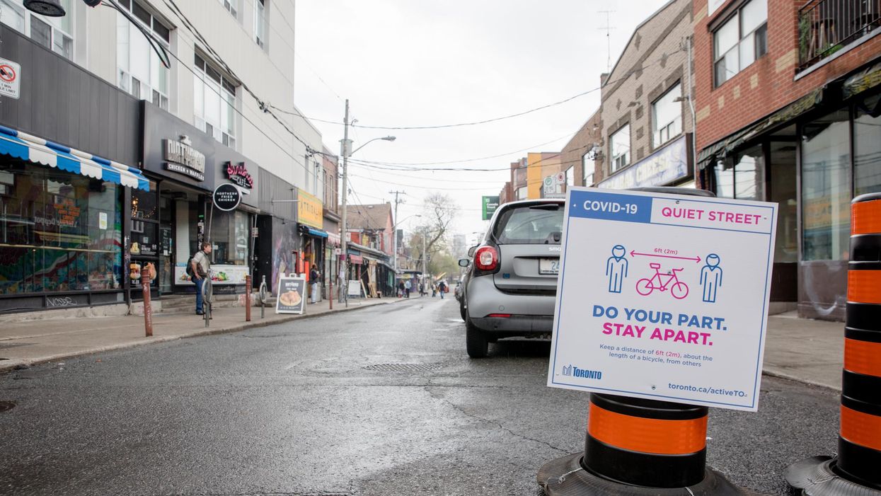 A COVID-19 sign in Kensington Market, Toronto, ON.