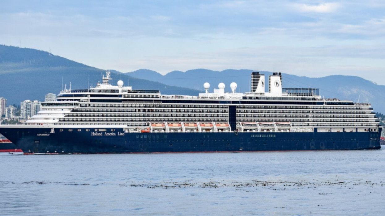 A cruise ship with mountains in the background.