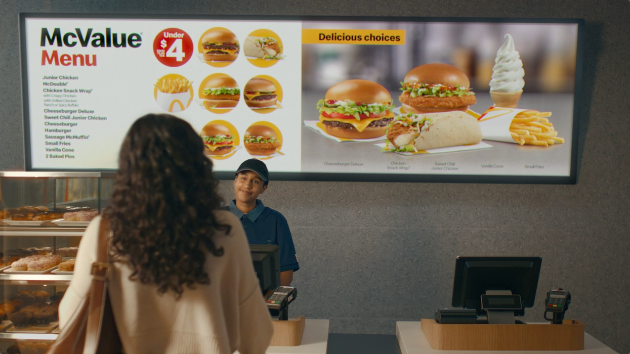 A customer at the register of McDonald's browsing the new McValue Menu.