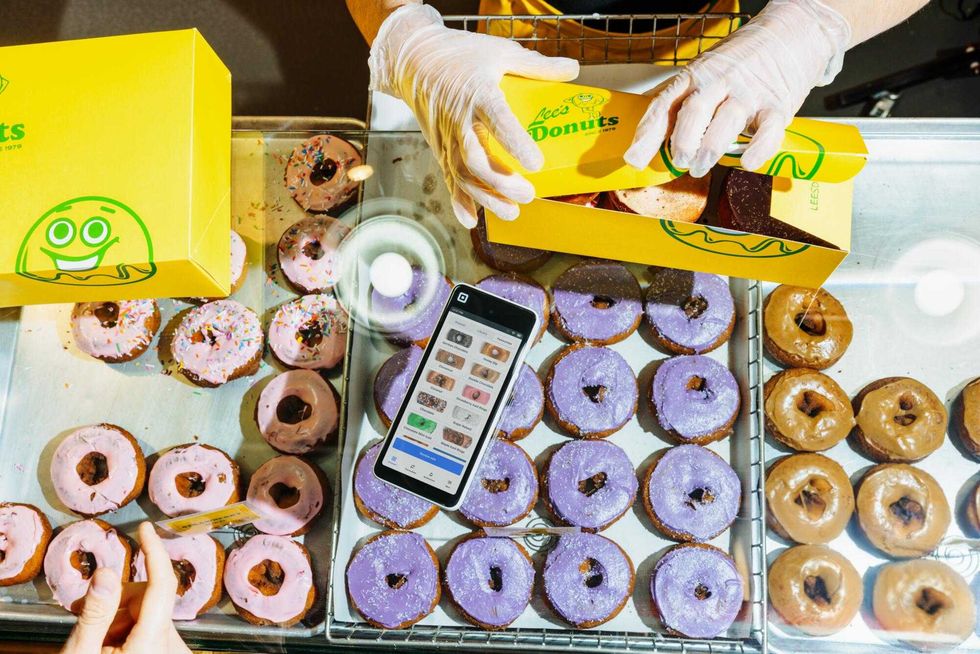 A customer purchasing donuts from Lee's Donuts.