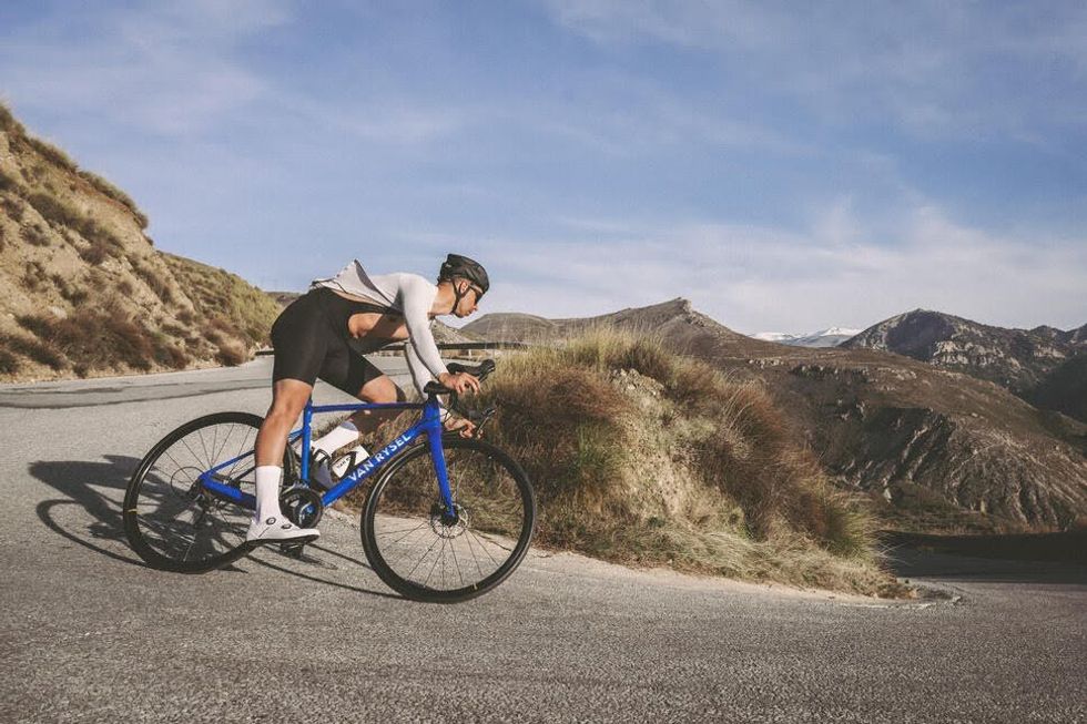 A cyclist riding down a hill.