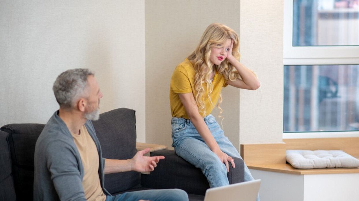 A dad having a discussion with his daughter.