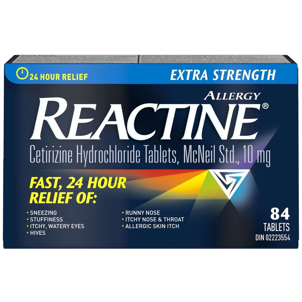 A dark blue box of Reactine Extra Strength 10 mg, 84 tablets.