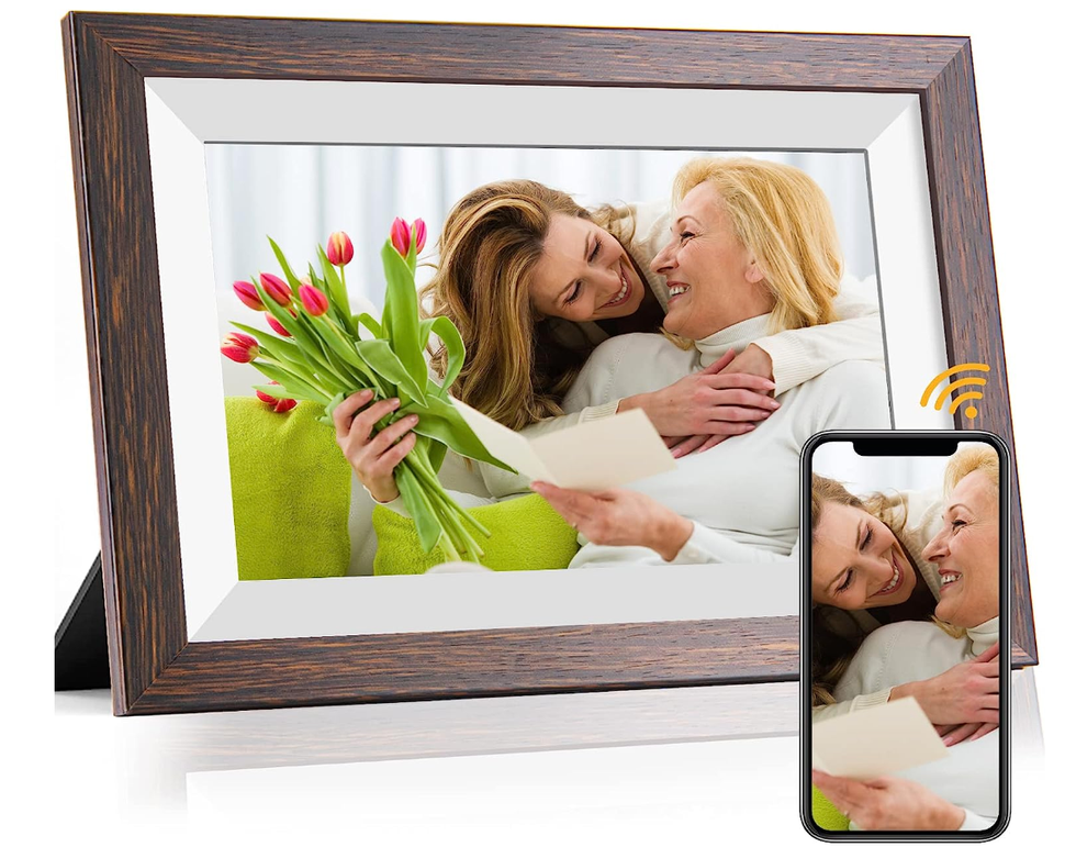 A digital photo frame showing a woman with her mom and an iPhone next to it with the same photo.