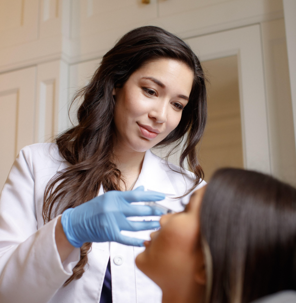 A doctor getting ready to inject botox into a patients face.
