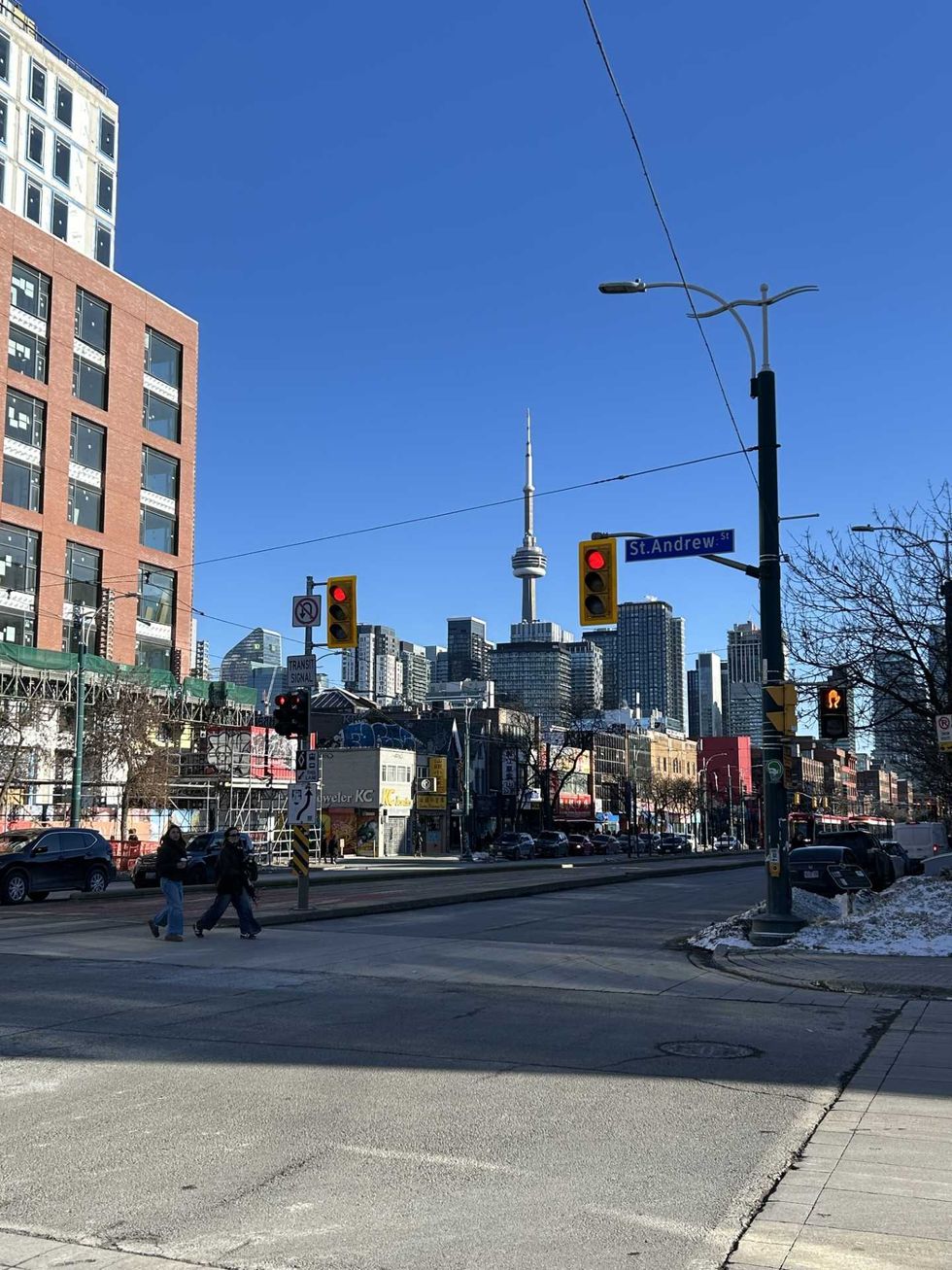 A downtown Toronto street with the CN Tower in the background.