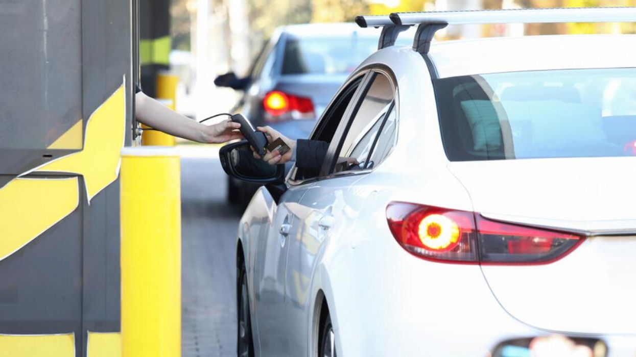 A driver pays at the drive-thru.