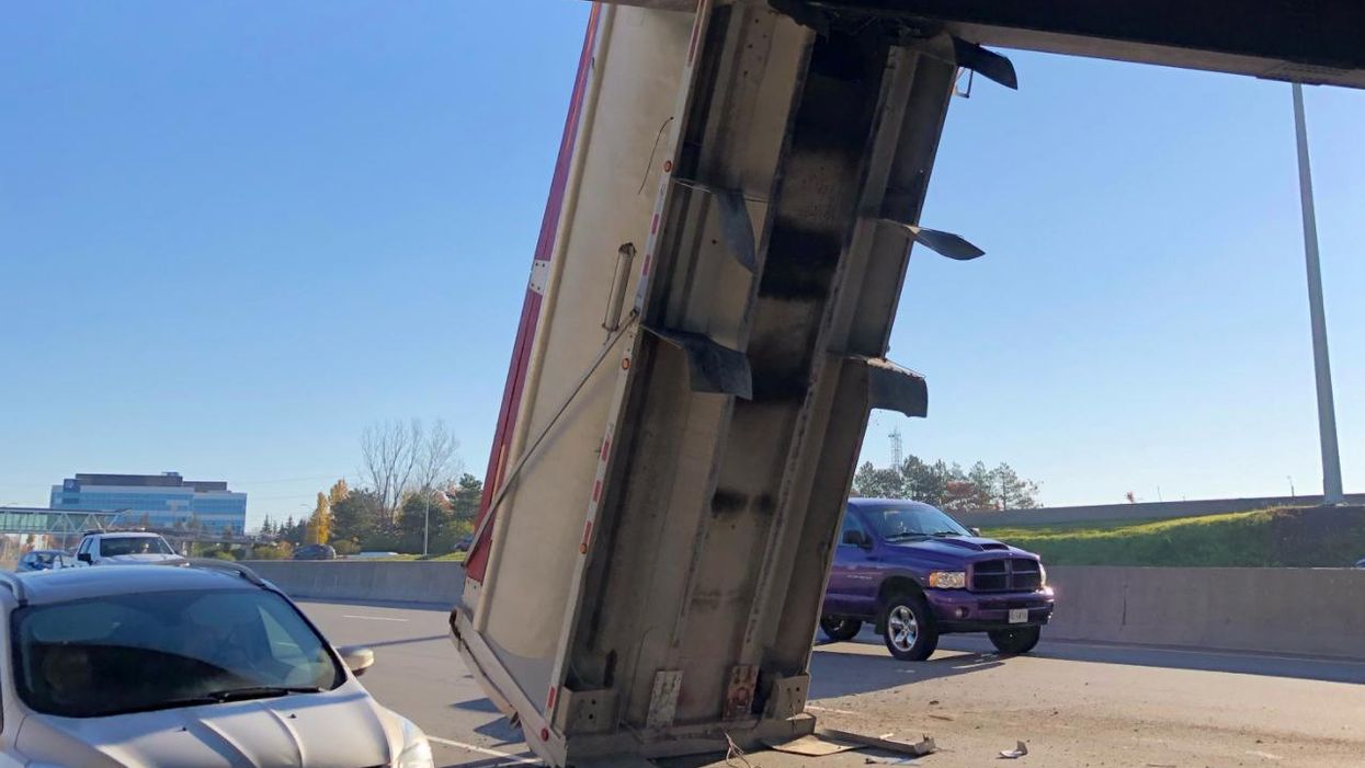 A Dump Truck In Ottawa Is Somehow Vertically Wedged Under The Vanier Pkwy RN & WTF?