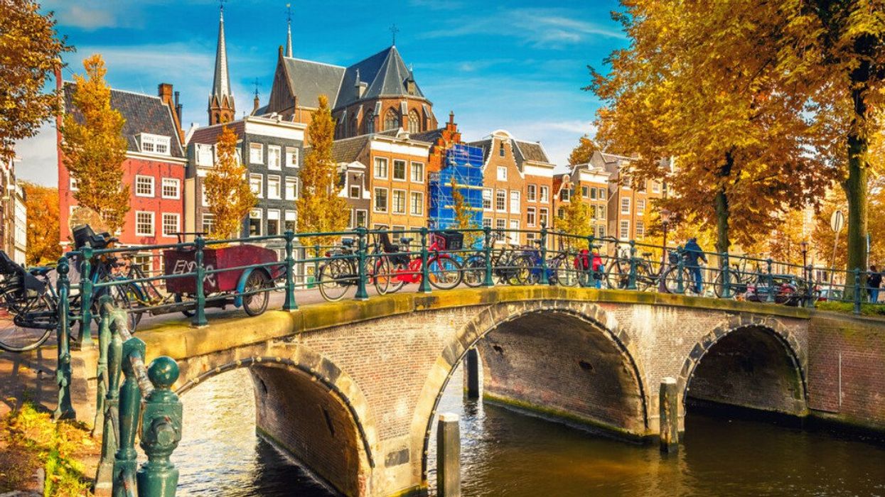 A European city with a bridge over a canal.