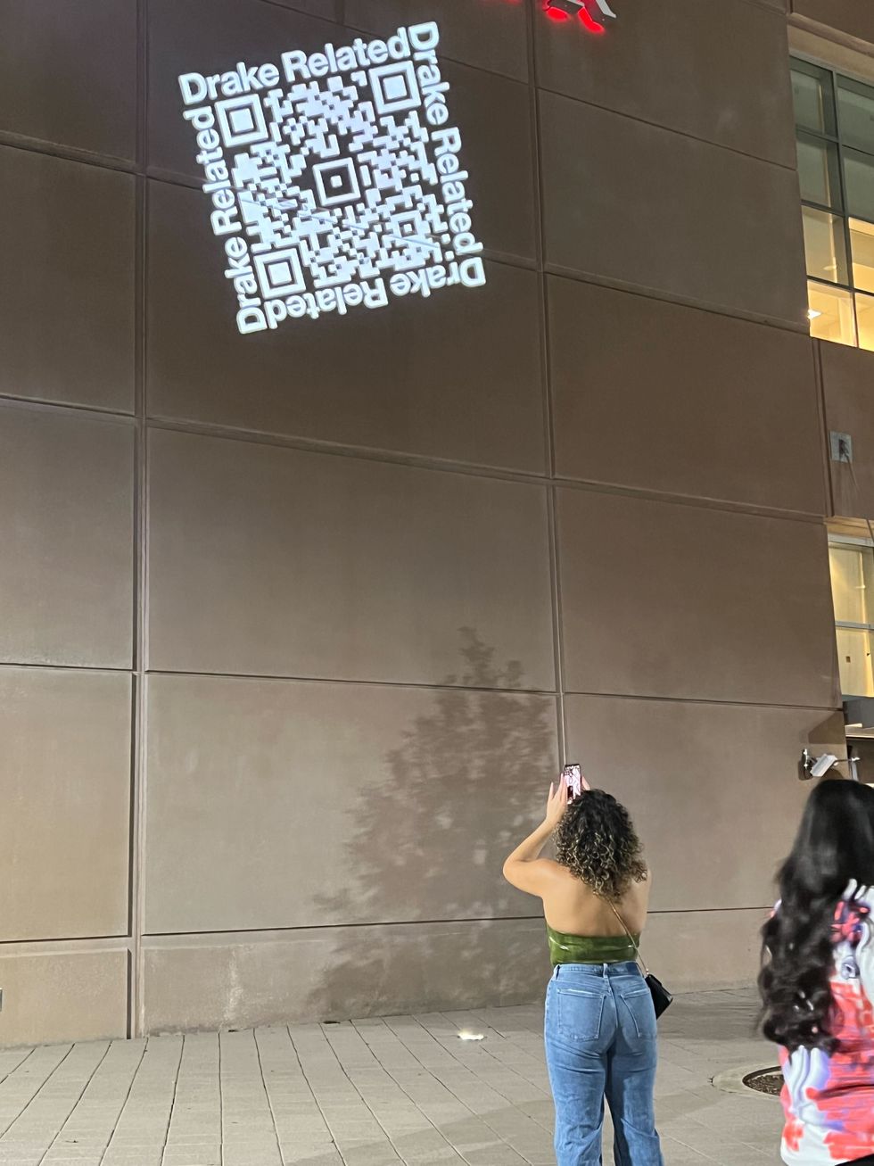 A fan scanning a QR code at a previous concert in Houston.
