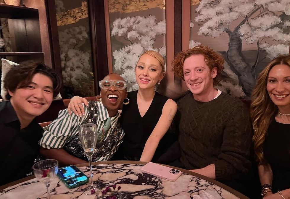 A few members of the cast Wicked out at a restaurant, including Ariana Grande and Ethan Slater.