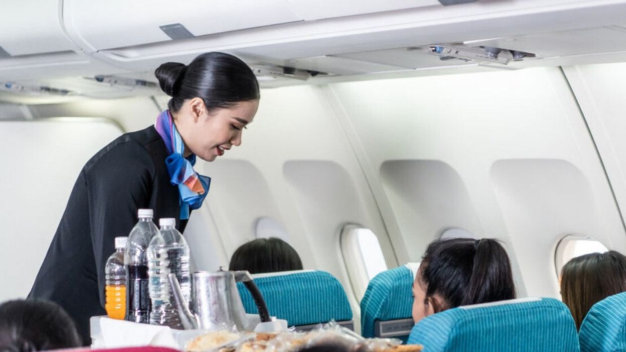 A flight attendant on a plane. 