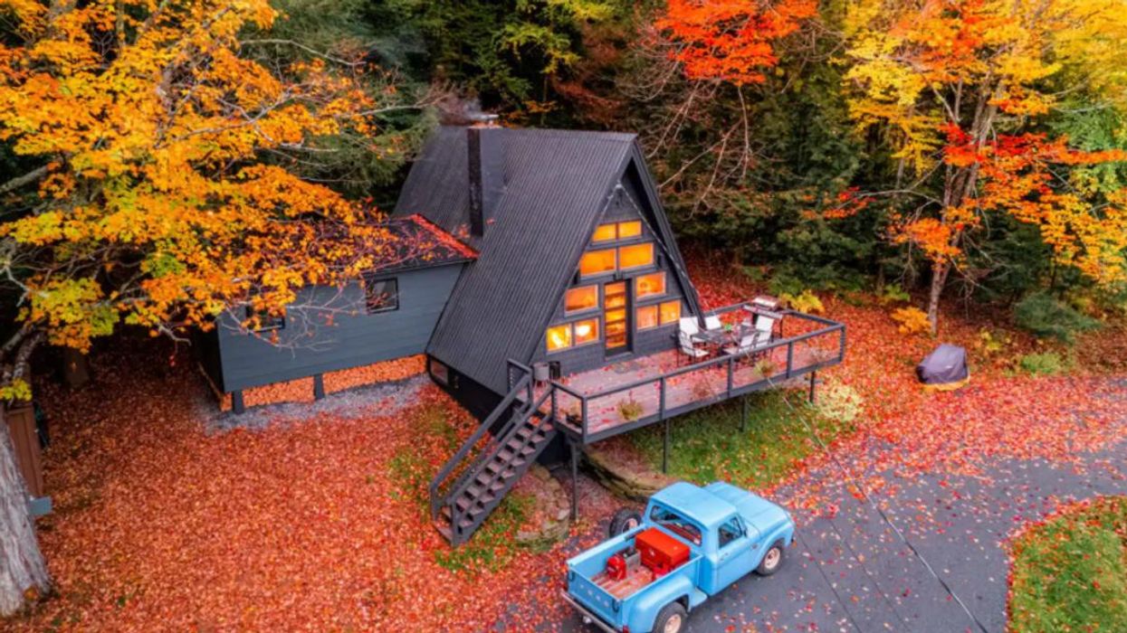 A-frame Airbnb surrounded by fall leaves.