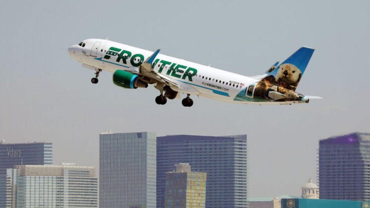 A Frontier Airline airplane taking off.
