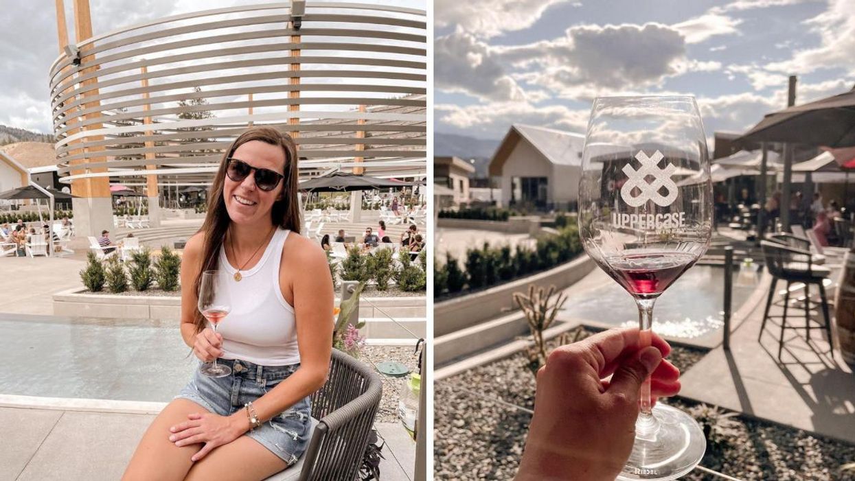 A girl sitting at District Wine Village with a wine glass. A wine glass is being held up.