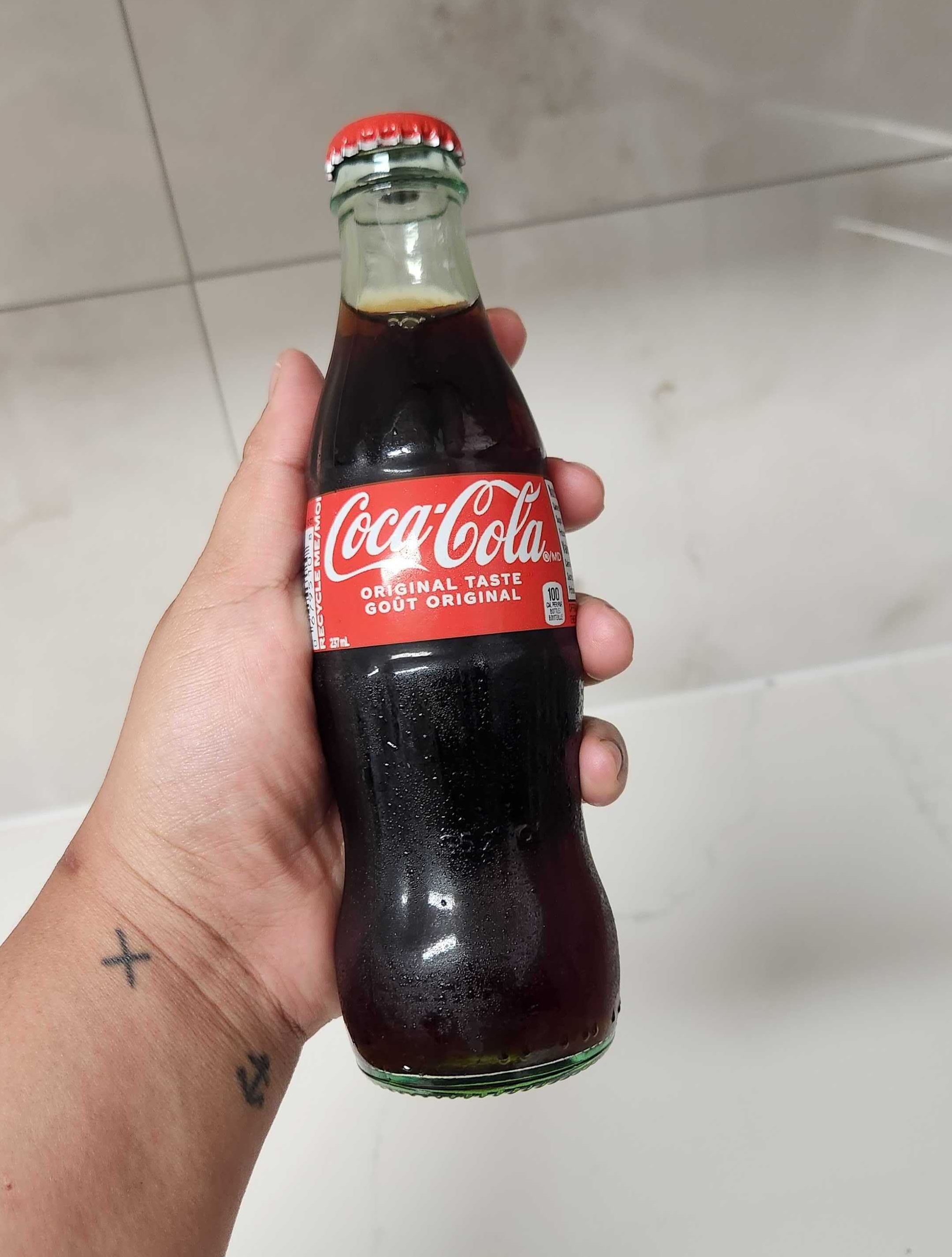 A glass bottle of Coca-Cola.