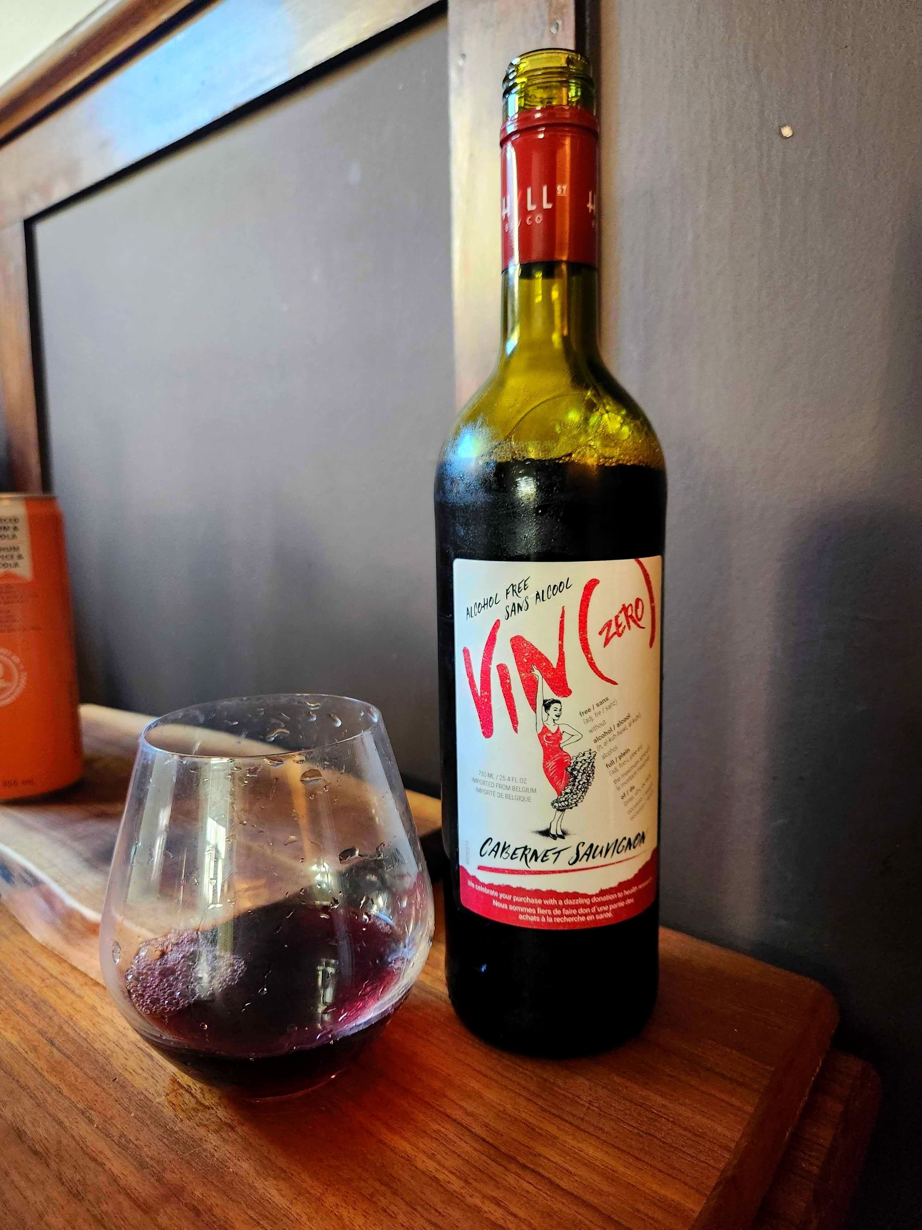 A glass of Vin(zero) Alcohol Free Cabernet Sauvignon beside a bottle of Vin(zero) Alcohol Free Cabernet Sauvignon.