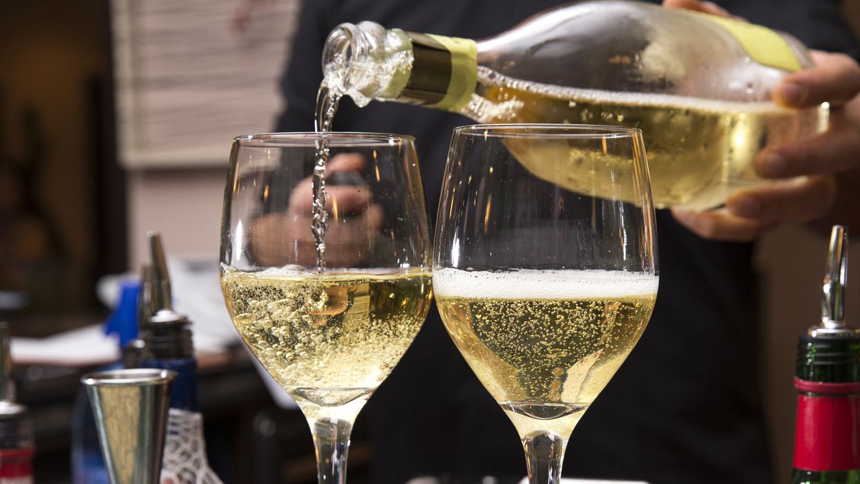 A glass of wine being poured.