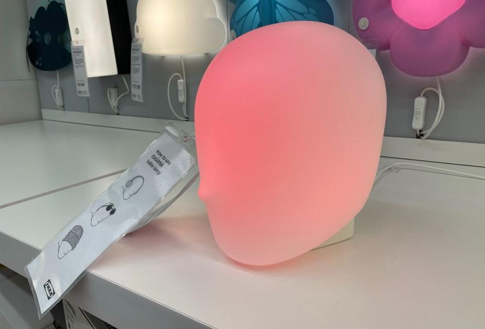 A glowing red ISK\u00c4RNA head-shaped lamp.