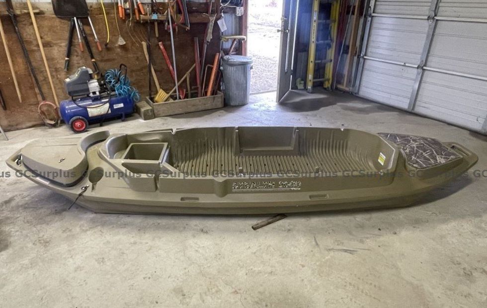 A green and camouflage boat.