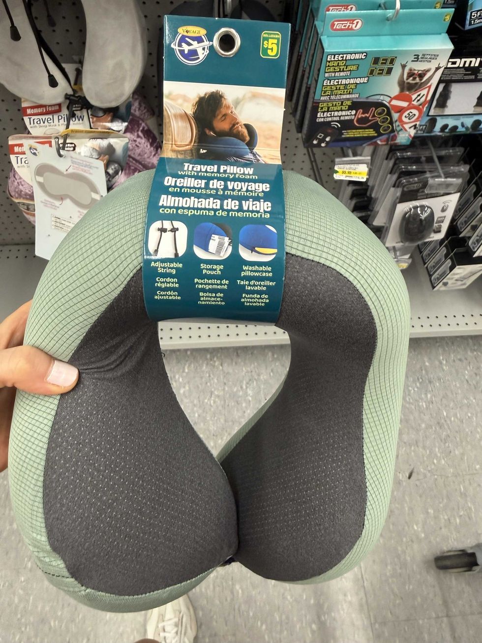 A grey and green travel pillow with memory foam.