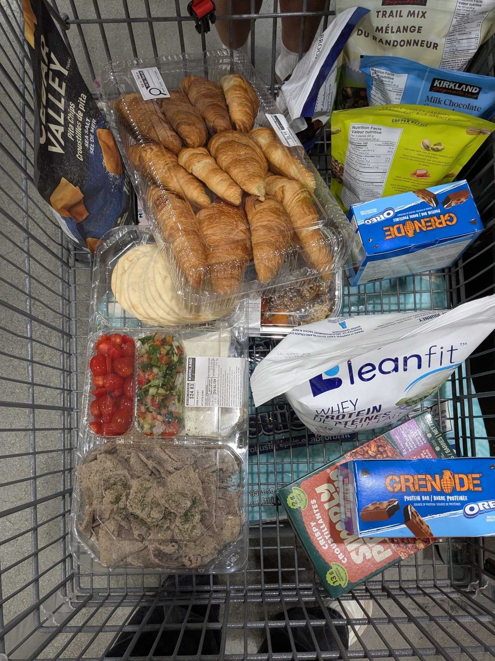 A grocery cart full of food items from Costco