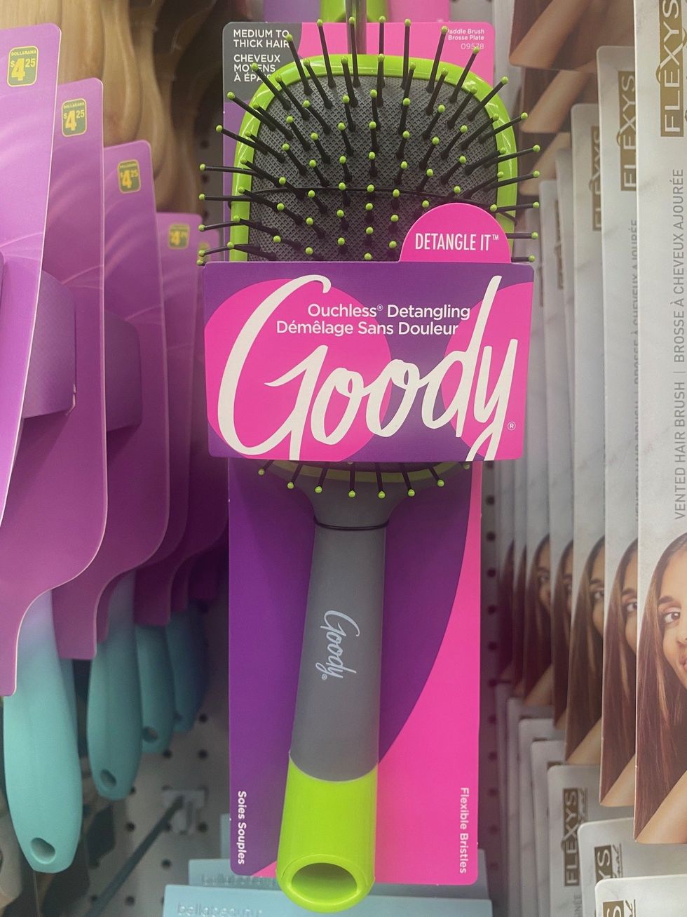 A hairbrush hanging on a store shelf.