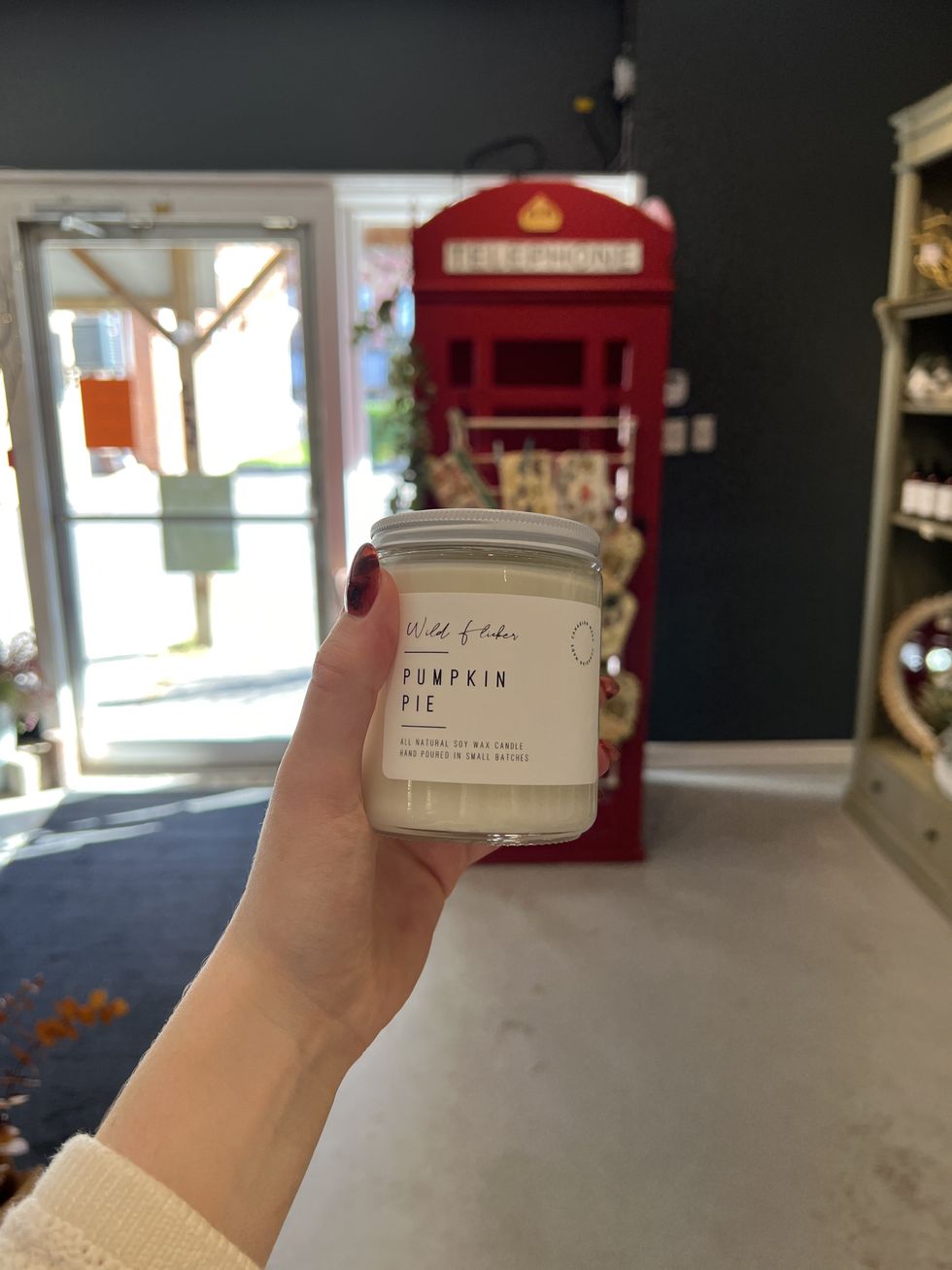 A hand holding a candle.