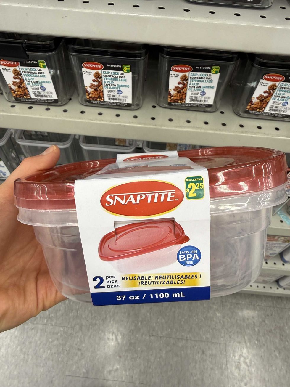 A hand holding a red plastic container with a label that says Snaptite reusable.