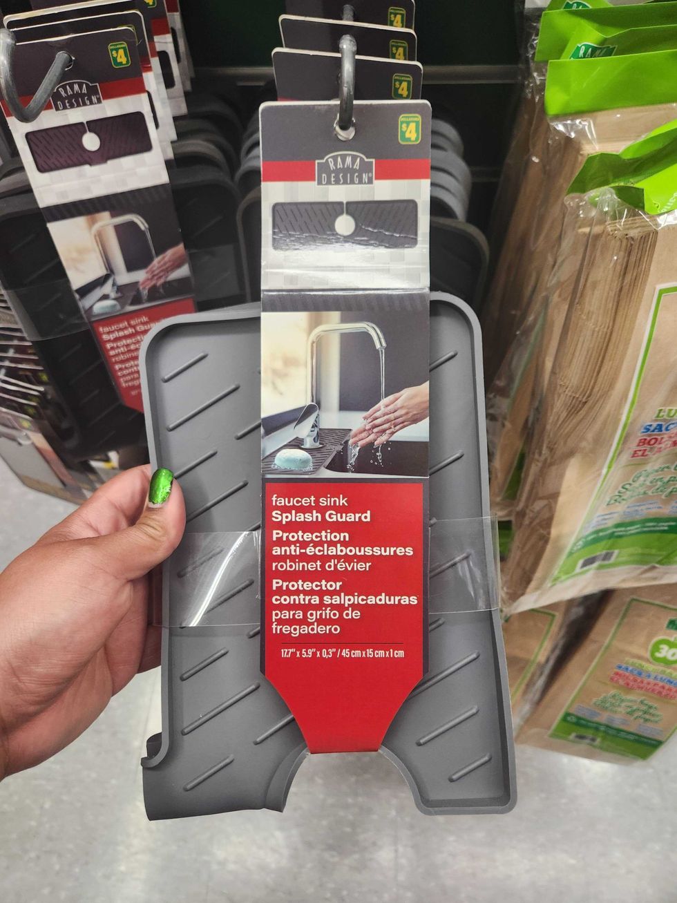 A hand holding a silicone splash guard.