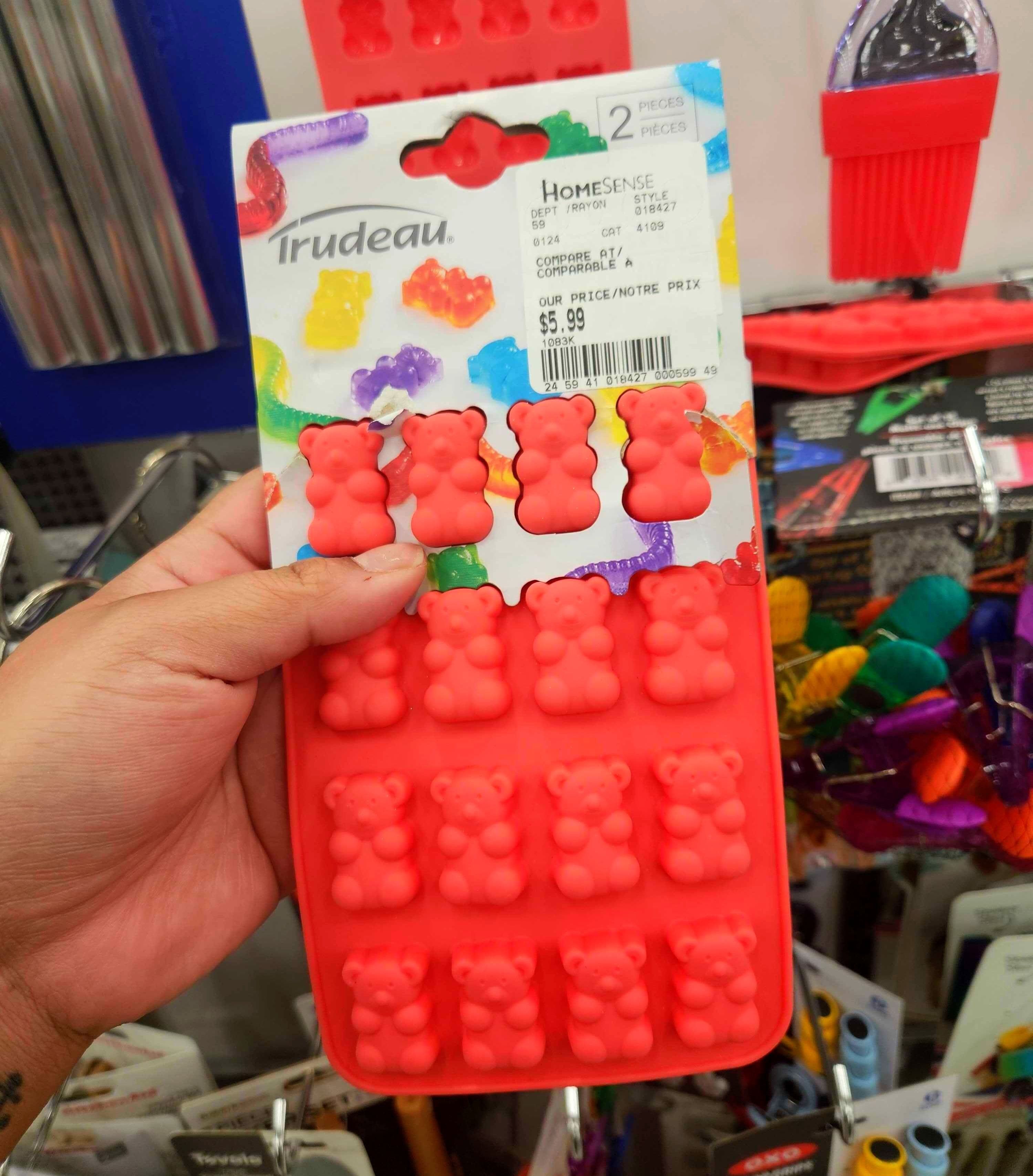 A hand holding Gummy Bear Molds.