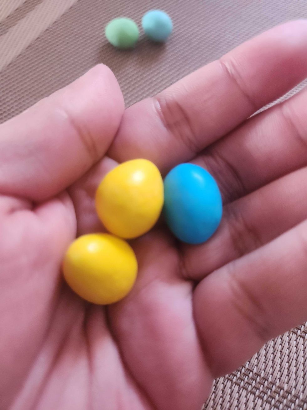 A hand holding Hershey's Reese Eggies.