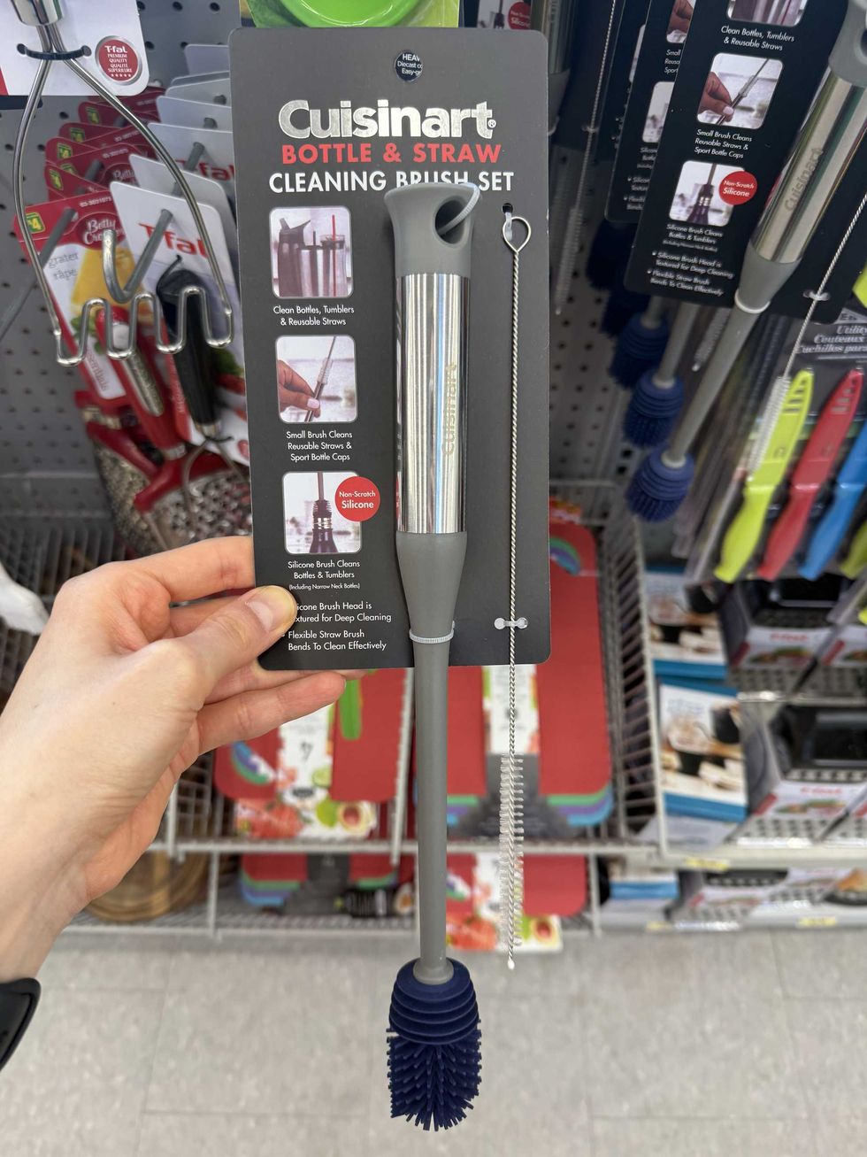 A hand holding two brushes that say bottle and straw cleaning brush set.