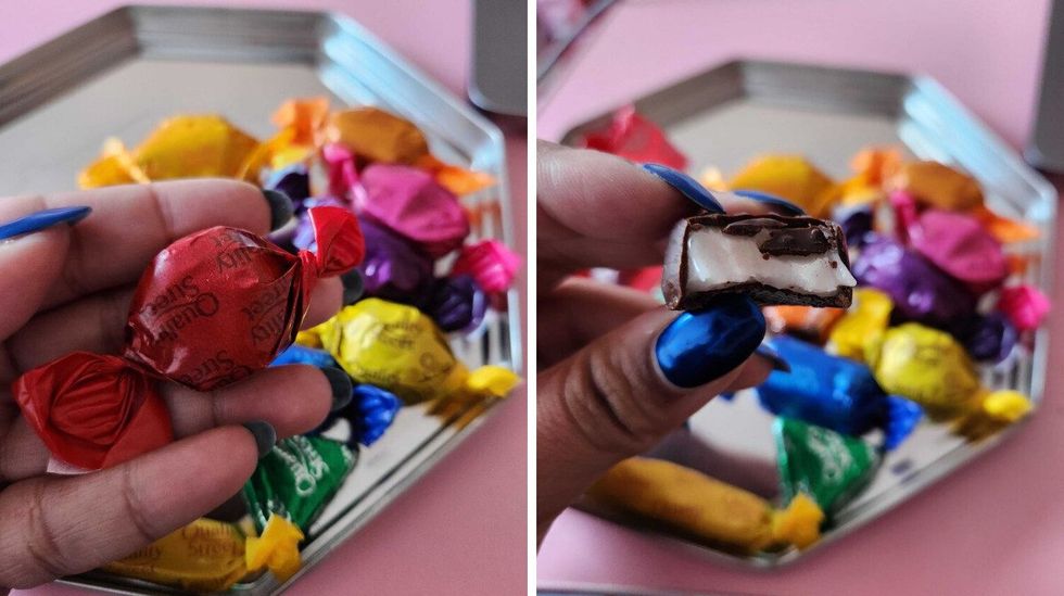 A hand with blue nails holding a chocolate in an red wrapper. Right: A hand with blue nails holding a chocolate with a bite taken out of it with white cream inside of it.