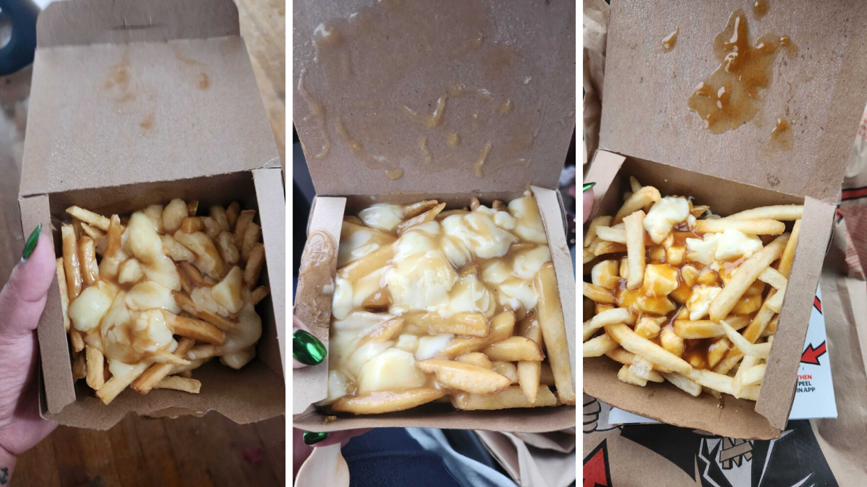 A hand with green nails holding poutines in brown boxes.