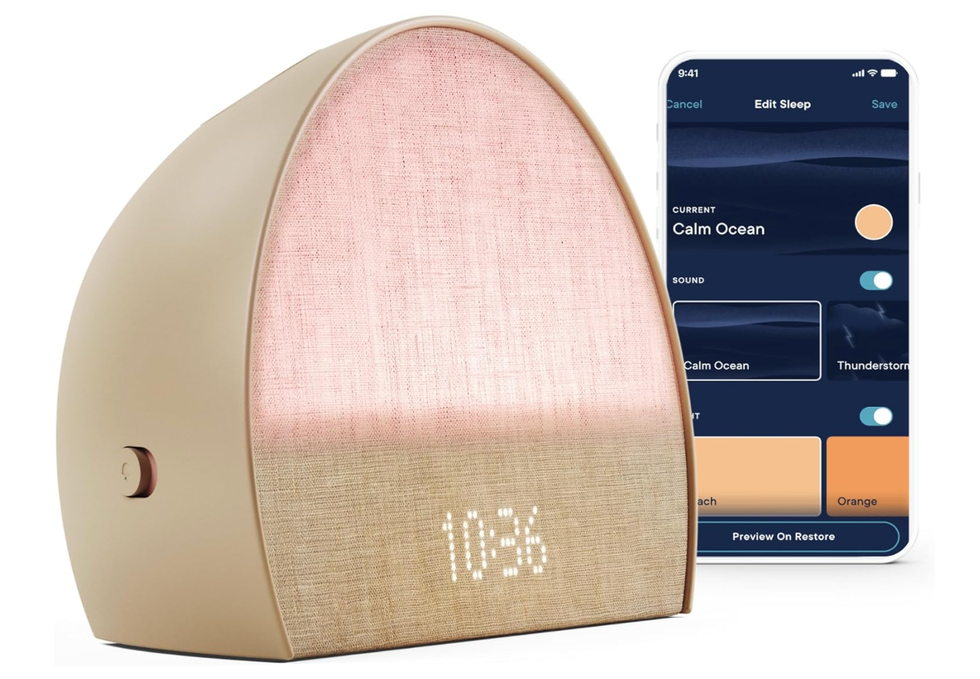 A Hatch alarm clock with an iPhone next to it.