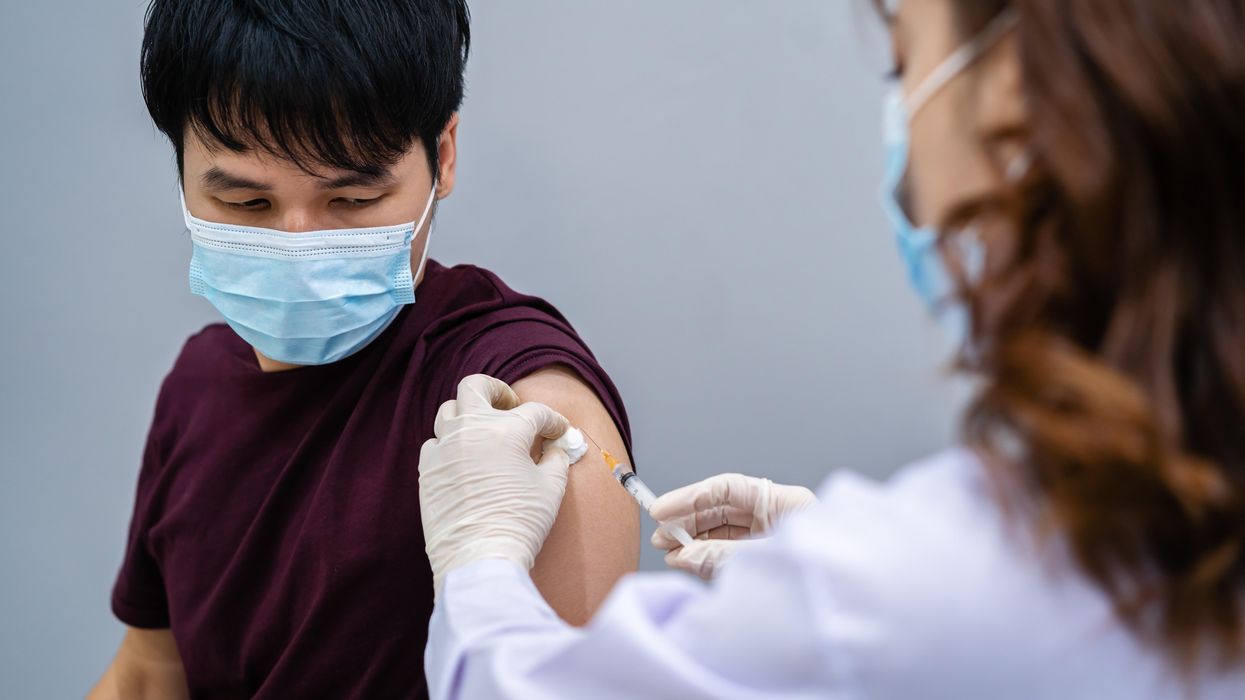 A health care worker administers a Covid-19 vaccine.