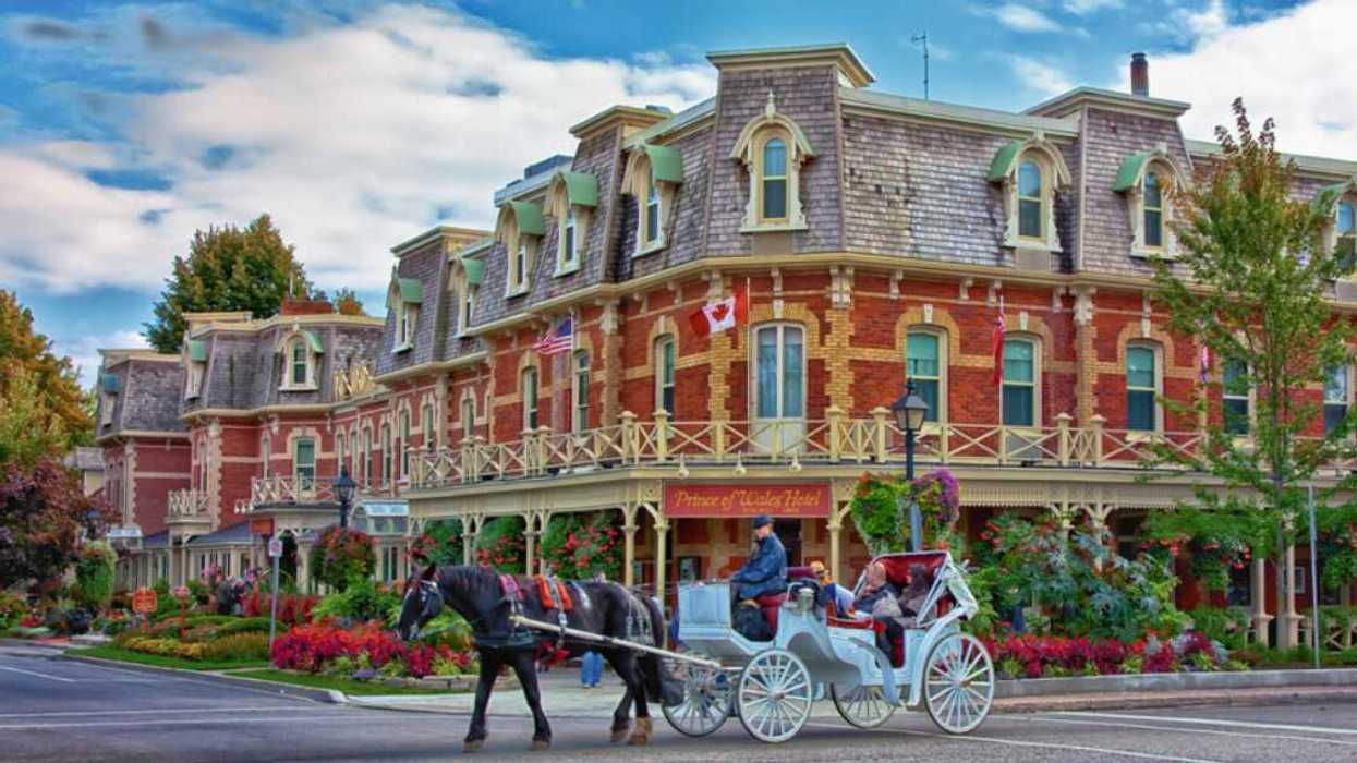 A horse-drawn carriage in front of a historic building.
