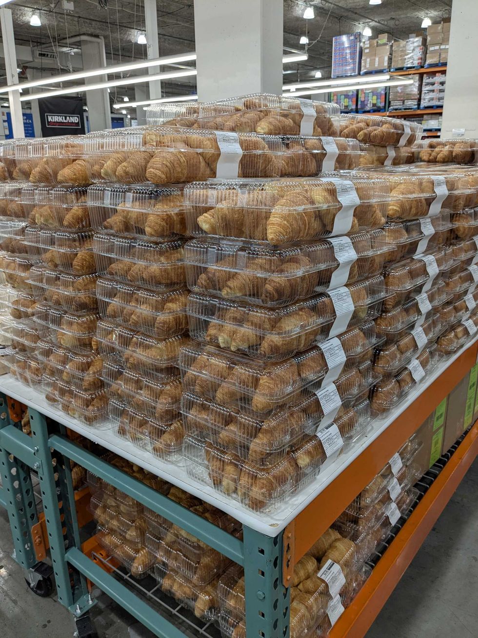 A huge stack of Costco croissants on display at a store