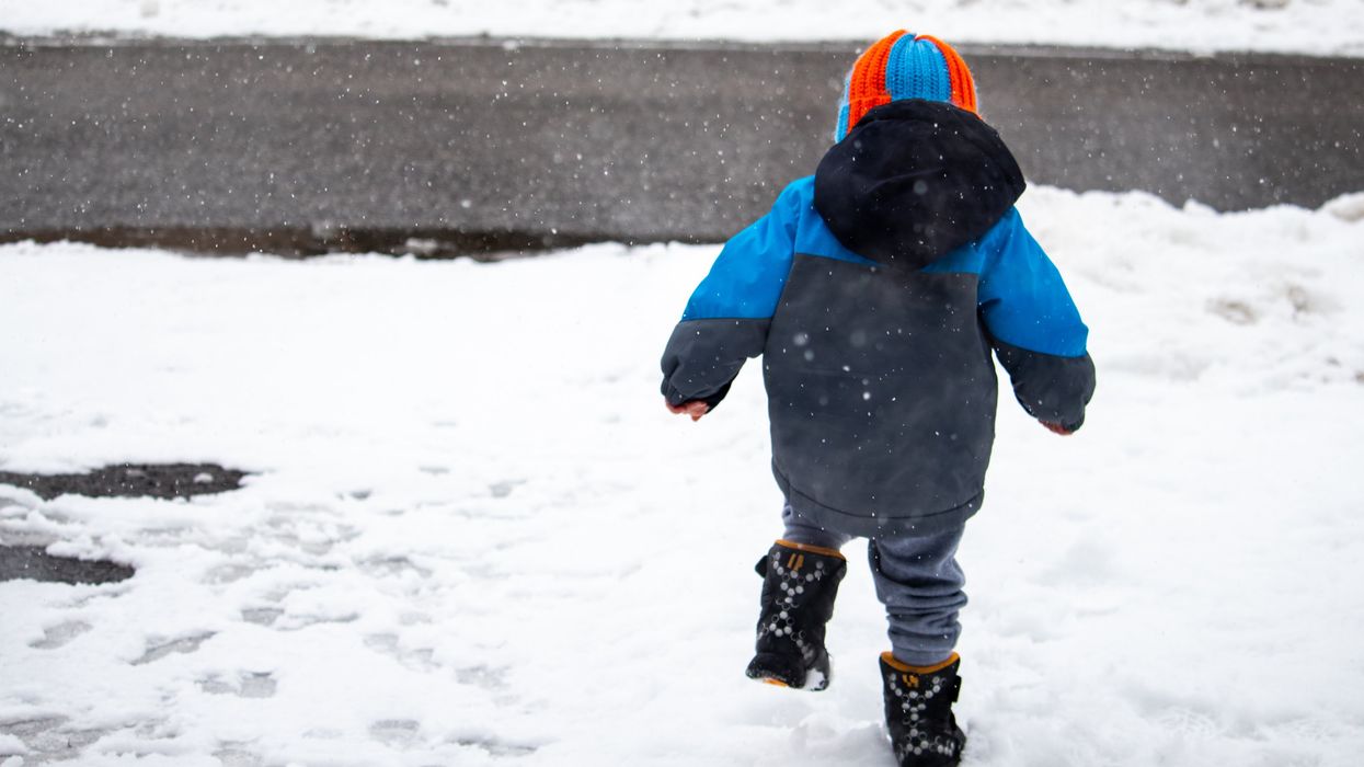 A kid playing in the snow.