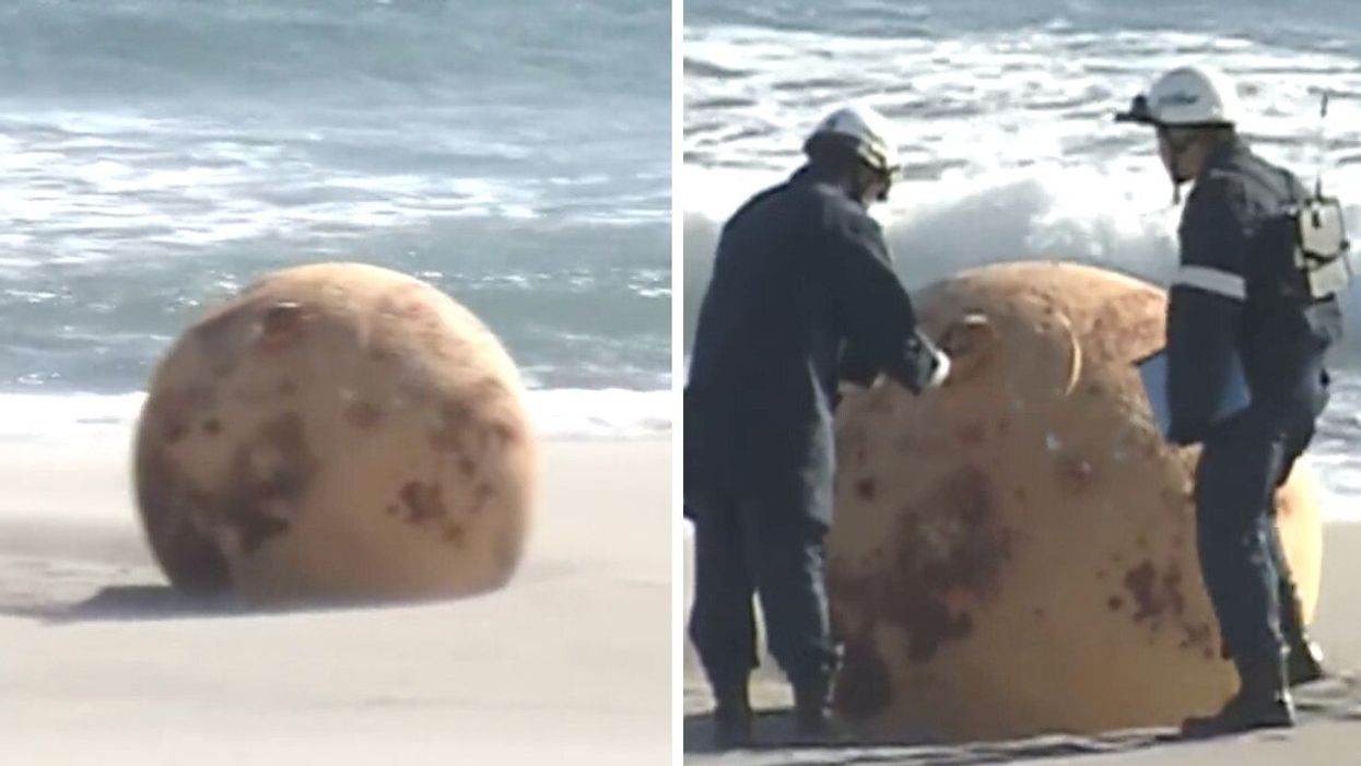 A large metal ball is shown on a beach in Japan.