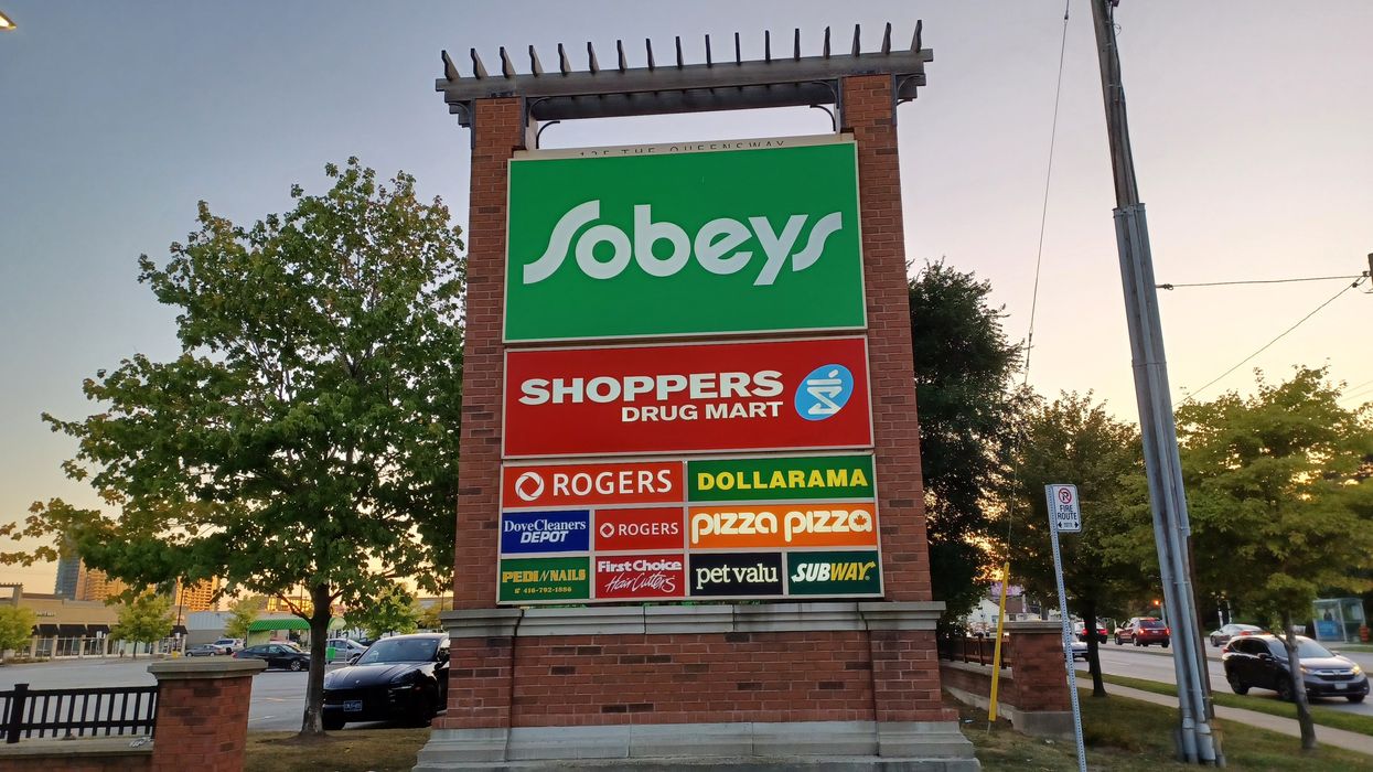 A large sign listing some of Canada's most famous retailers, including Dollarama, Shoppers Drug Mart and Sobeys.