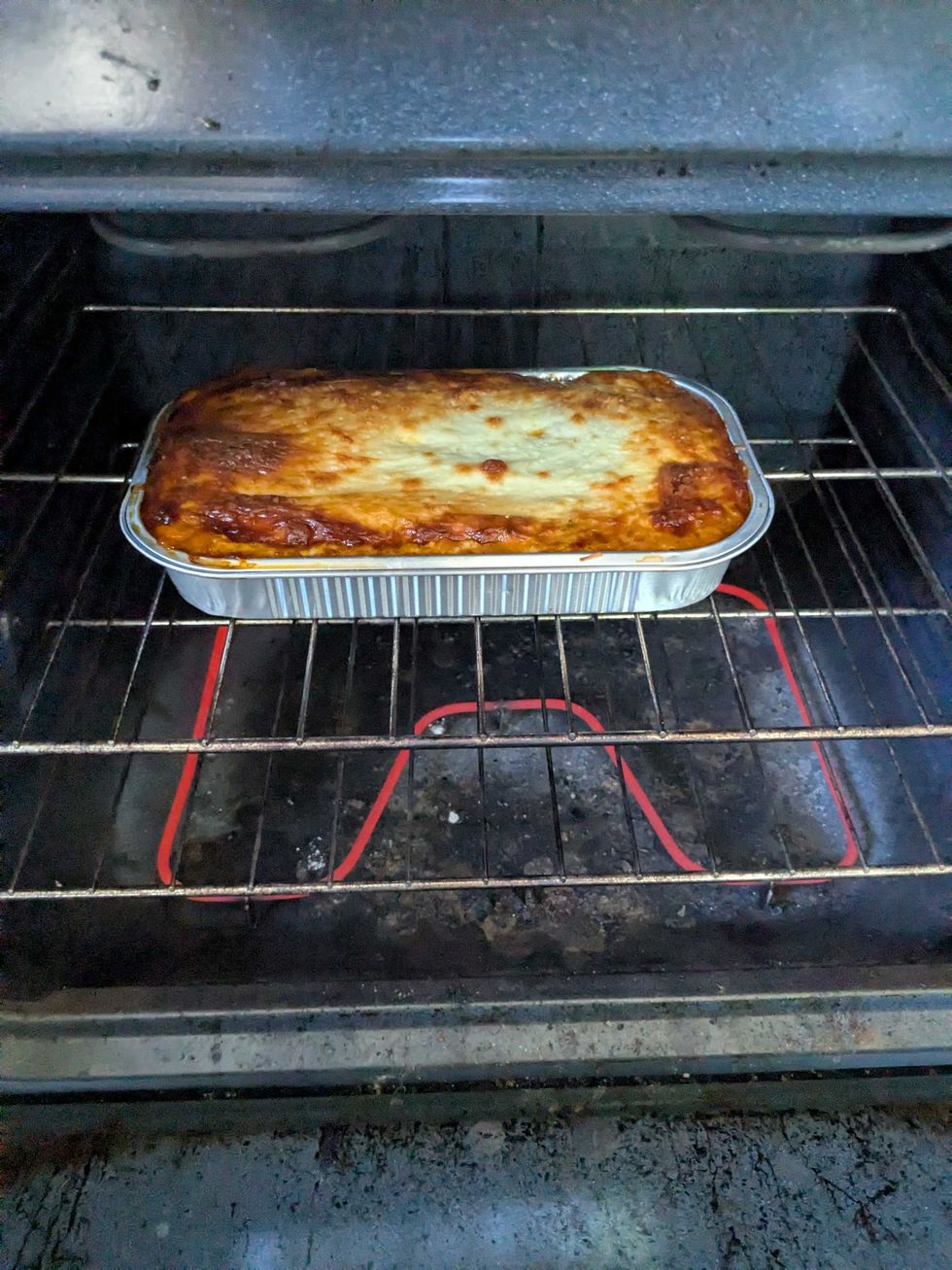 A lasagna cooking in an oven