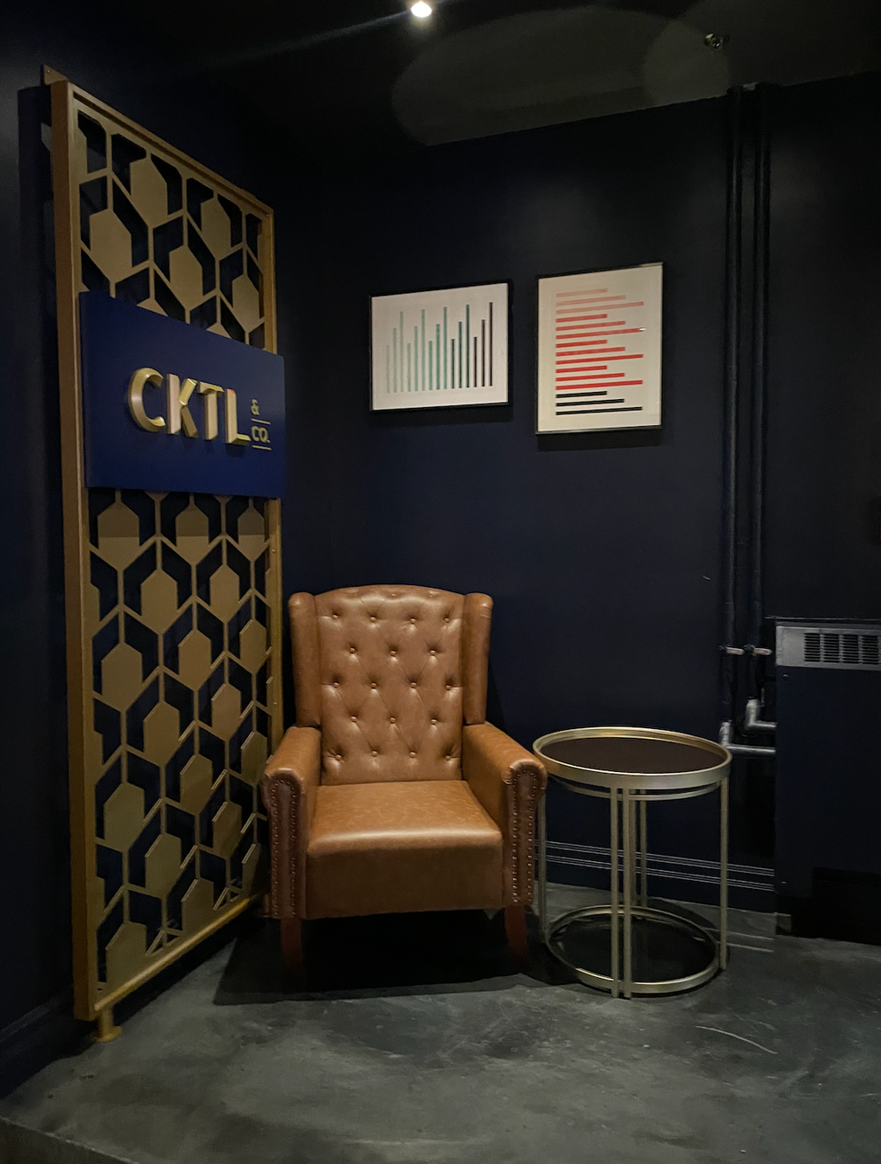 A leather chair and side table in the corner of CKTL&Co.