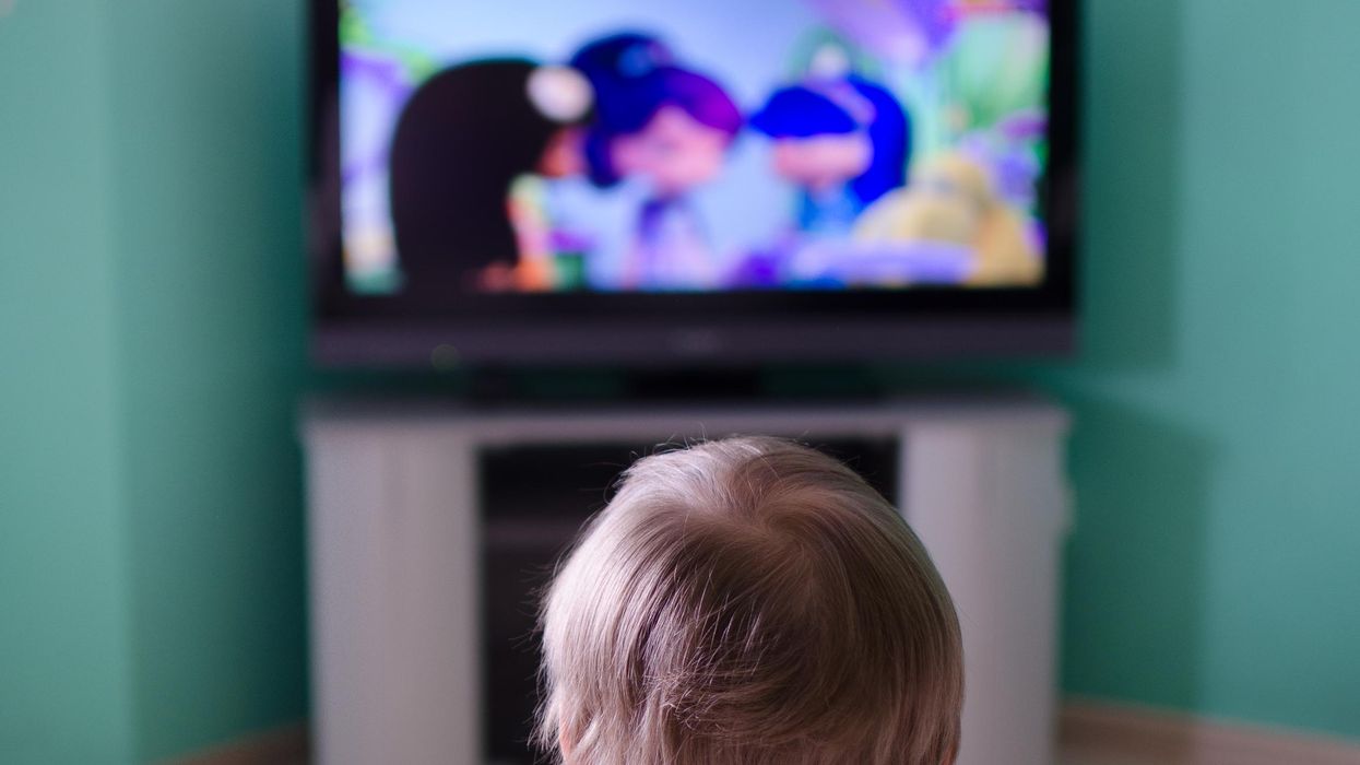 A little boy watching TV.