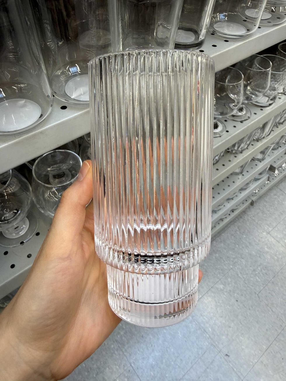 A long glass for drinking with a ribbed design.