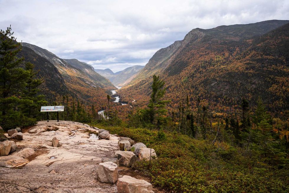 A look out overlooking a river and mountains in the Charlevoix mountain sector.