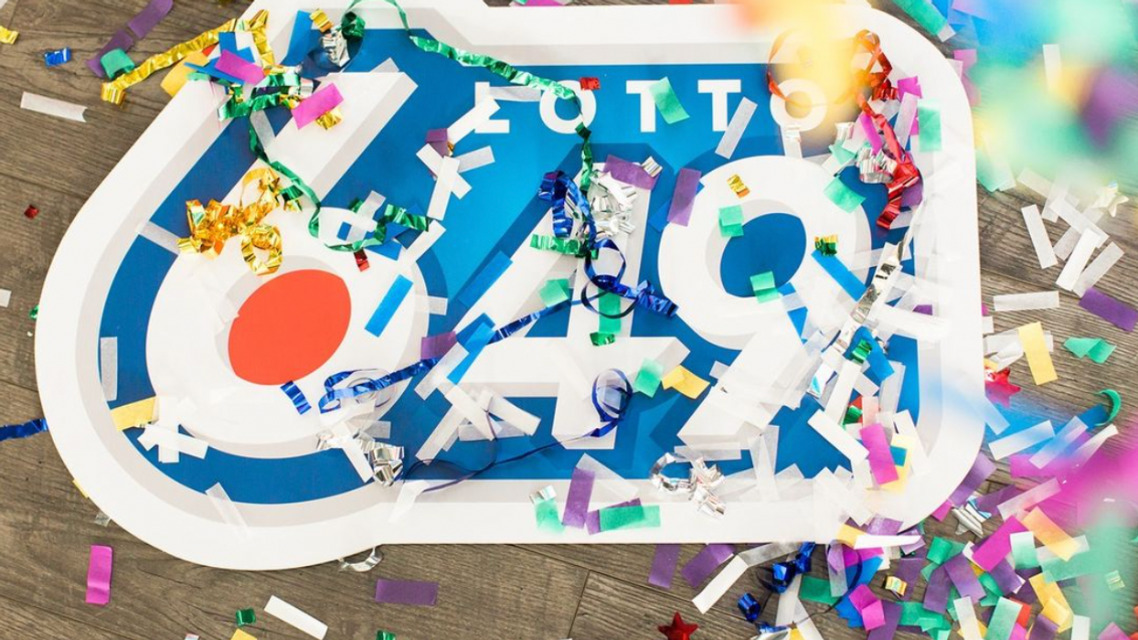 A Lotto 6/49 sign covered in confetti.